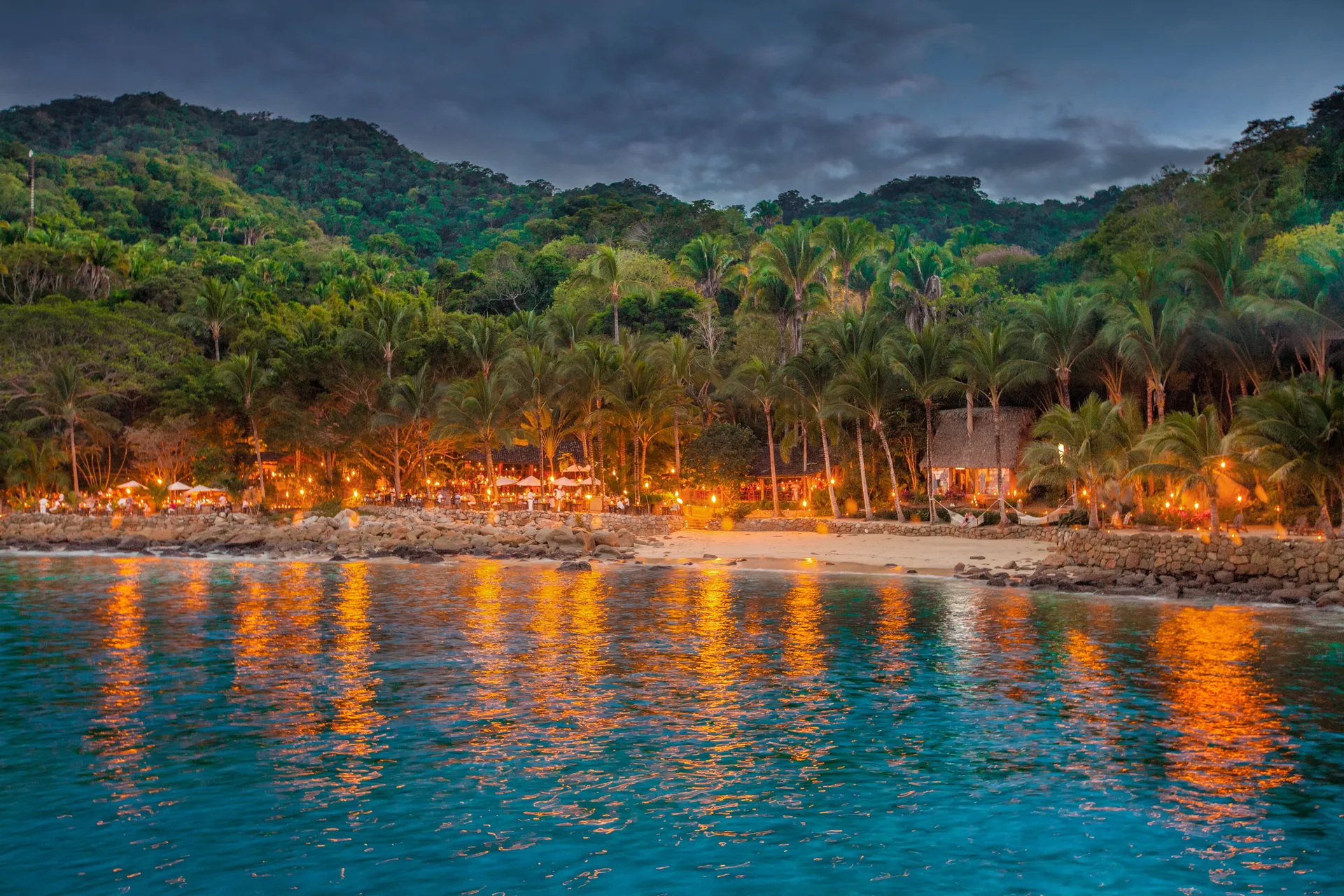 Torch-lit dining terrace at Las Caletas at night