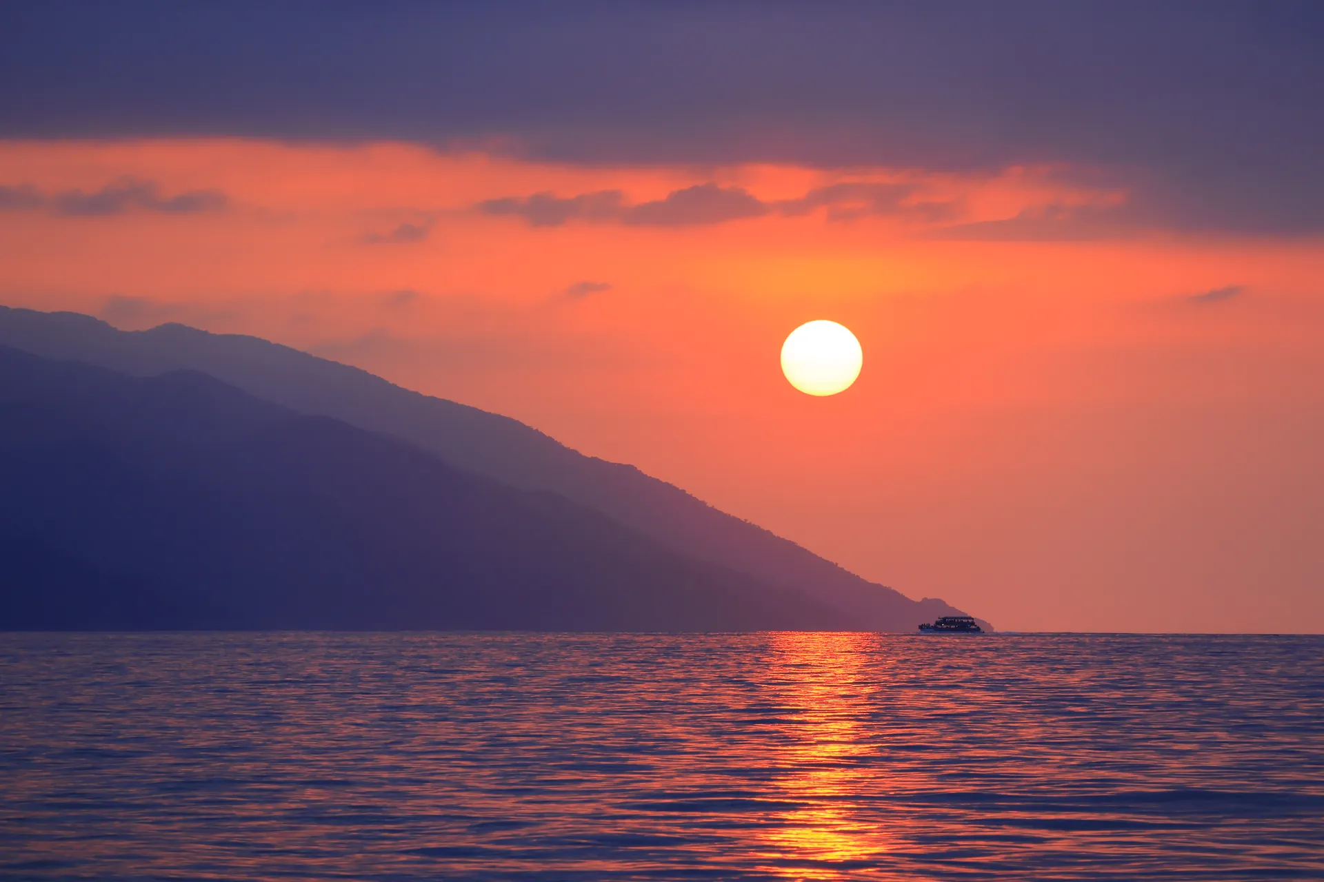 Catamaran crossing Banderas Bay at sunset toward Las Caletas