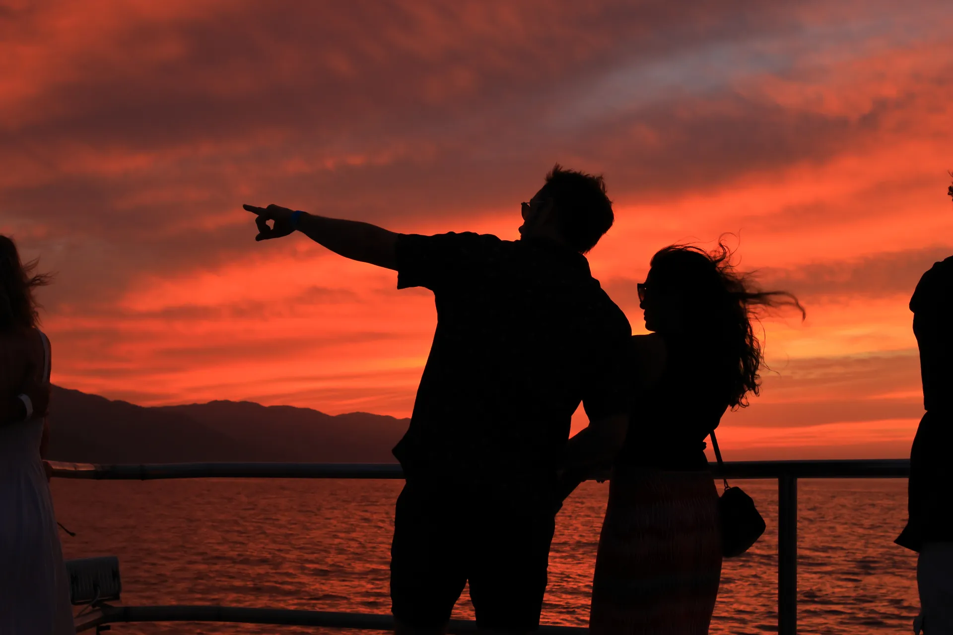 Guests on the catamaran deck during the sunset crossing to Las Caletas